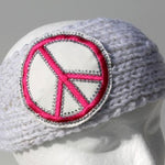 White knit head wrap with large pink peace sign